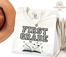 a hat, sunglasses and t - shirt with the words first grade printed on it