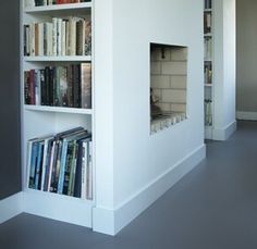 a white book shelf filled with lots of books