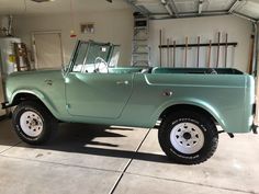 an old pick up truck parked in a garage