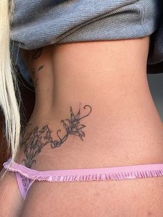 a woman's stomach with tattoos on it