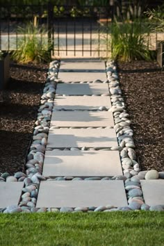 a walkway made out of stones and grass