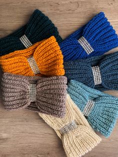 four knitted headbands with bows on them