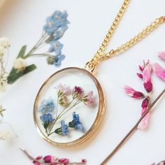 A beautiful and unique Botanical inspired terrarium necklace with real forget me not flowers and pink baby breath flowers (gypsophila) For memories of a close one, for true love and to show someone you will never forget them 💕The flower is encapsulated in a crystal clear Resin which is Non-toxic, No VOCs, No fumes, No solvents, Non-flammable, Non-hazardous, No BPA. The necklace chain is gold plated solid brass or stamped 14k gold filled chain as shown in last photo. This chain is much more long Dainty Flower Pendant Jewelry For Keepsake, Dainty Flower Pendant Jewelry Keepsake, Dainty Birth Flower Jewelry For Keepsake, Delicate Birth Flower Jewelry For Keepsake, Delicate Charm Necklace With Pressed Flowers For Gifting, Delicate Pressed Flowers Charm Necklace Gift, Delicate Charm Necklace With Pressed Flowers For Gift, Delicate Charm Necklace With Pressed Flowers As A Gift, Dainty Charm Necklace With Pressed Flowers