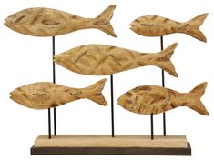 four wooden fish on stand with white background