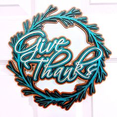 a sign that says give thanks hanging on a door