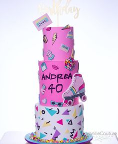 a three tiered birthday cake decorated with pink and purple items, including roller skates