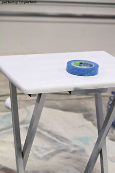 a white table with a blue tape on it