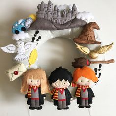 a harry potter wreath with three dolls on it