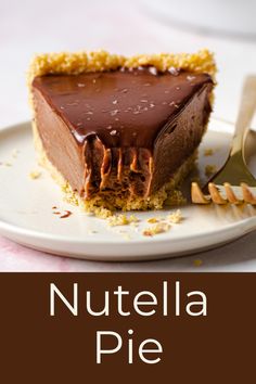 a piece of chocolate pie on a white plate with a gold fork next to it