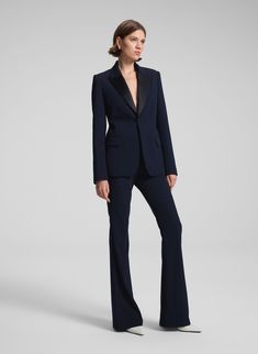 The Sophie II Pant is crafted from our drapey wool gabardine in rich navy blue. This high-rise, non-stretch silhouette features a slim, narrow thigh that opens into a gentle flare, designed to be worn with a heel for a slight break at the hem. Complete with slash pockets, it offers a modern, sophisticated look. Shop Bottoms. Styling Tip: Pair with everything from tailored blazers to lustrous satin tops. Fall Evening Pantsuit With Pressed Crease, Chic Navy Bottoms For Formal Occasion, Elegant Navy Bottoms For Fall, Elegant Navy Dress Pants For Work, Chic Navy Formal Bottoms, Tailored Elegant Navy Pants, Elegant Tailored Navy Dress Pants, Elegant Tailored Navy Pants, Tailored Dress Pants For Fall Evening Events