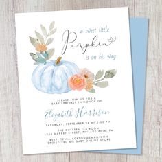 a blue pumpkin baby shower is shown on a wooden table with the words, sweet little pumpkin it's on his way