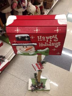 a large red box with a snowman on it's side in a store