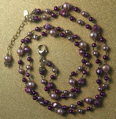 Hand knotted faceted pinkish purple fresh water pearls, large pink fresh water pearls, smaller light plum fresh water pearls, vivid purple fresh water pearls and Bali sterling silver beads are featured in this double strand necklace. All metal is 925 sterling silver and stamped by the artist. Matching earrings are available. For questions and or requests feel free to contact me. This necklace ships free via USPS Priority Mail with insurance and would make a great gift. Thanks for looking. Baroque Pearls Necklace, Pearl Centerpiece, Genuine Pearl Necklace, Hand Knotted Necklace, Knotted Necklace, Pinkish Purple, Bali Silver, Double Strand Necklace, Silver Bead Necklace