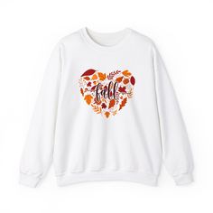 Embrace the cozy vibes of the season with our Halloween/Fall sweatshirt! Crafted from soft, comfortable fabric, this sweatshirt is perfect for celebrating autumn and Halloween. Whether you're pumpkin picking, enjoying a bonfire, or just soaking in the fall festivities, this sweatshirt is a must-have addition to your seasonal wardrobe. ❤With TrendyFoxApparel, our garments are more than just a piece of clothing; they are a canvas for self-expression. Elevate your style and express your individuality with our exceptional shirts and sweatshirts -- the perfect way to showcase your passions, interests, and personality. Crafted with comfort in mind using premium quality materials, choose from a variety of designs in our shop that resonate with your unique tastes. Thank you for supporting our smal Casual Fall Sweater With Heart Graphic, Casual Heart Graphic Sweater For Fall, Long Sleeve Heart Graphic Sweater For Fall, Cozy Fit Graphic Print Tops For Fall, Winter Crew Neck Sweatshirt With Heart Graphic, Winter White Tops With Heart Graphic, White Tops With Heart Graphic For Winter, Fall Crew Neck Top With Heart Graphic, Cozy Fit Graphic Sweatshirt For Fall