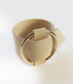 Statement cuffs are what it's about. We are totally swooning over our new microfiber cuff bracelet, so fabulous! Made from creamy colored microfiber with a large, ring shaped, gold buckle. You will receive two free gifts with purchase. Free shipping. Adjustable Gold Leather Chic Bracelet, Adjustable Gold Leather Bracelet Chic Style, Chic Adjustable Cream Jewelry, Chic Beige Wristlet Gift, Chic Beige Wristlet As A Gift, Gold Leather Cuff Bracelet, Chic Beige Wristlet For Gift, Chic Adjustable Cream Bracelets, Chic Adjustable Cream Bracelet