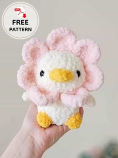 a hand holding a small stuffed animal in pink and white with the words free pattern on it