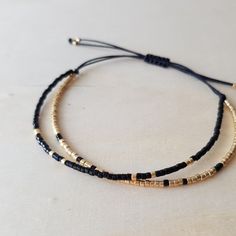 Dainty Black Gold Beaded String Bracelet Adjustable - Etsy Gold Beaded Minimalist Friendship Bracelets, Gold Minimalist Friendship Bracelets With Round Beads, Handmade Minimalist Gold Friendship Bracelets, Minimalist Handmade Gold Friendship Bracelets, Black Beaded Bracelets With Gold Beads For Gifts, Adjustable Black Bracelets With Gold Beads, Minimalist Beaded Bracelets With Adjustable Length, Black Dainty Friendship Bracelets As Gift, Minimalist Friendship Bracelets With Round Beads