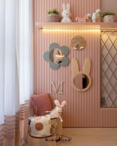 a room with pink walls and decorations on the wall