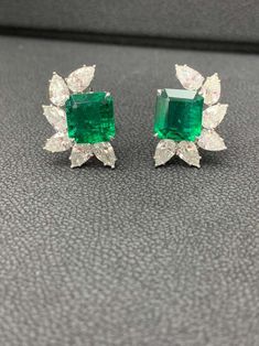 For Sale on 1stDibs - A simple and fashionable pair of Certified earrings showcasing a cluster of pear shape diamonds surrounding emerald-cut Emerald halfway, set in a beautiful Luxury Emerald-cut Diamond Earrings For Formal Occasions, Luxury Emerald Cut Diamond Earrings For Formal Occasions, Green Emerald Cut Diamond Earrings For Formal Events, Emerald Cut Green Diamond Earrings For Formal Events, Green Emerald Cut Diamond Earrings For Formal Occasions, Formal Green Emerald Cut Diamond Earrings, Formal Green Diamond Cluster Earrings, Emerald Cut Diamond Earrings For Formal Occasions, Formal Baguette Cut Emerald Earrings