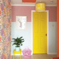 a yellow door in a pink and white room