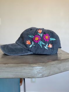 Unique hand embroidered baseball cap. Has a bright floral design on a vintage style hat. Its a really fun accessory with one of a kind details. The hat is a one size fits most with an adjustable strap. Embroidered Trucker Baseball Cap For Beach, Fun Hats With Embroidered Logo One Size, Fun Hats With Embroidered Logo, Fun Embroidered Logo Hat One Size, Fun Embroidered Snapback Hats, Vintage Curved Bill Snapback Hat For Spring, Embroidered Baseball Cap For Beach In Spring, Adjustable Embroidered Baseball Cap For The Beach, Vintage Adjustable Baseball Cap For Spring