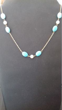 Fancy, original, handmade necklace for women and girls. This necklace is made up of a very pretty chain on which, at the drop of the necklace, turquoise pearls separated by a white mother-of-pearl pearl have been attached. There are three sets of turquoise and pearly pearl. This necklace, with its lightness and elegance, is ideal to be offered or worn for occasions or celebrations such as: Christmas, New Year's Day, Valentine's Day, Birthday, Mother's Day, etc.... .. Elegant Turquoise Chain Necklace Gift, Turquoise Pearl Necklace Gift, Turquoise Necklace With Pearl Pendant For Gift, Turquoise Pearl Necklaces With Pearl Charm, Elegant Turquoise Necklace With Delicate Chain For Gift, Blue Pendant Necklace With Pearl Drop, Elegant Turquoise Pearl Necklace, Turquoise Pearl Pendant Necklace As Gift, Turquoise Necklace With Pearl Drop For Gift