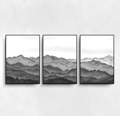 three black and white mountains are shown in this minimalist landscape art print on the wall