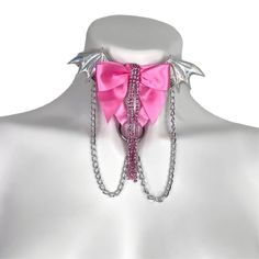 Choose the color elastic, bow, wing, and hardware you want to recreate this look to fit your style! Adjustable neck band. Petal Pink elastic, halo wings, medium pink bow, crystal rhinestones, silver chains, and silver hardware pictured here. Satin Elastic • Adjustable Straps • Hand Wash • Air Dry Pink Party Jewelry With Butterfly Knot, Adjustable Pink Jewelry For Cosplay, Pink Party Jewelry With Butterfly Knot Detail, Pink Punk Jewelry For Party, Pink Adjustable Chain Choker Jewelry, Leg Garters, Pink Adjustable Choker, Leather Choker Collars Pink, Thigh Garter