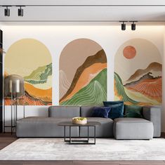 a living room with couches and paintings on the wall