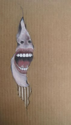 an open cardboard box with a drawing of a mouth and teeth