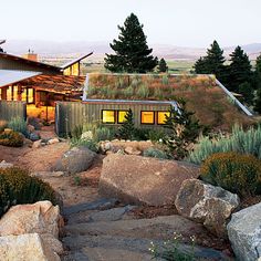 the house is surrounded by rocks and plants