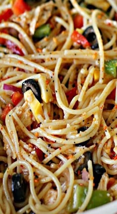 pasta with olives, peppers and other ingredients in a pan