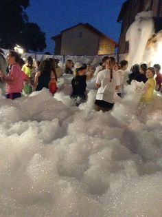 children playing in foamy water at night