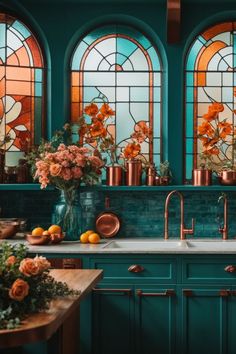 a kitchen with stained glass windows and copper pots filled with flowers on the counter top