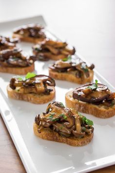 mushroom bruschetta on a white plate with the title above it