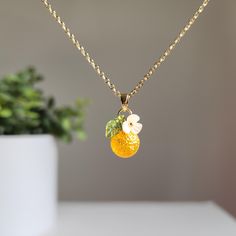 Elevate your style with your exquisite, personalized orange fruit necklace. You choose the design. We hand make the necklace for you. We offer various colors and materials to choose. The necklace is delicately crafted with intricate details, capturing the beauty of nature in its design. Lightweight and comfortable to wear 🍊Premium Material: handmade with Czech glass oranges, acrylic flowers, acrylic leaves, and 14K gold plated/925 sterling silver plated (hypoallergenic) necklace chain. 🌺 Size: Orange Pendant Charm Necklaces For Gifts, Orange Charm Jewelry For Gifts, Handmade Orange Charm Necklace As A Gift, Handmade Orange Charm Necklace For Gift, Orange Jewelry With Fruit Design For Gifts, Orange Flower Pendant Jewelry For Gift, Orange Flower Pendant Jewelry Gift, Orange Fruit Design Jewelry For Gift, Orange Fruit Design Jewelry Gift