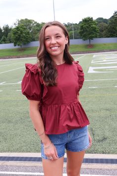 Elevate your wardrobe with our Maroon Peplum Ruffle Top! Made from high-quality poplin cotton, this top features puff sleeves and feminine ruffle details. With ties at each side, it offers a perfect fit. Whether for pre-fall or gameday, it's a must-have addition to your collection! Maroon peplum ruffle top Poplin cotton Puff sleeves Peplum hem Side ties Gameday top Maroon gameday top Peplum Crop Top, Maroon Shirts, Gameday Outfit, Peplum Hem, Peasant Top, Short Leggings, Ruffle Top, Shop Swimwear, Pre Fall