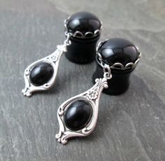 "These made-to-order elegant dangle plugs feature round glass gems in your choice of color, set in silver plated scalloped settings. Dangling from each is a fancy Victorian antiqued silver plated frame with swirl and floral details. The settings hold small oval black glass gems. They are really lovely plugs, simple yet with an elegant touch. These would make beautiful wedding or prom gauges, too. This made-to-order pair is available in the following size/styles: 9/16\" (14mm) - Black Acrylic wit Bridal Gauges, Gauge Plugs, Wedding Plugs, Lucis Caelum, Small Gauges, Earrings Prom, Dangle Plugs, Piercing Inspo, Plug Earrings