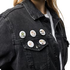 a woman wearing a denim jacket with buttons on the front and back of her jacket