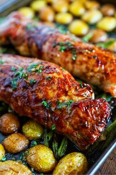 two meats and potatoes on a pan with parsley garnish in the middle