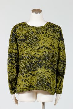 Revamp your wardrobe with our Prairie Cotton Sweatshirt. This lightweight French Terry cotton sweatshirt boasts a wide crewneck and long sleeves, creating a loose and boxy fit that falls high on the hips. Its casual, comfortable and stylish design makes it a must-have for any fashion-savvy individual. Available in a moss green color with an abstract black animal print. No pockets. Made in USAFabric: 100% CottonCare: Machine Wash Cold, Tumble Dry LowMedium - Bust 52", Hips 50", Length 25" Fall Layering Blouse With Crew Neck, Oversized Long Sleeve Graphic Sweater, Oversized Crew Neck Blouse For Layering, Oversized Graphic Print Blouse For Fall, Oversized Fall Blouse With Graphic Print, Green Stretch Long Sleeve Top With Crew Neck, Fall Graphic Print Sweatshirt For Layering, Oversized Crew Neck Blouse For Fall, Fall Crew Neck Blouse With Graphic Print