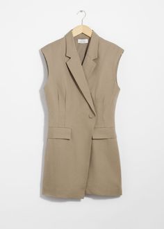 Sleeveless blazer mini dress featuring an accentuated waistline and padded shoulders for a structured silhouette.• V-cut neckline• Overlapping, single-button lapel• Duo welt pockets• Buckle detail at the back for an adjustable fit• Length of dress:86cm / 33.9" (EU 36 / UK 8 / US 4) Workwear Mini Dress With Structured Shoulders, Mini Dress With Structured Shoulders For Work, Chic Workwear Mini Dress With Structured Shoulders, Chic Mini Dress With Structured Shoulders For Work, Semi-formal Sleeveless Blazer With Hidden Button Closure, Semi-formal Sleeveless Spring Blazer, Chic Spring Career Mini Dress, Spring Chic Career Mini Dress, Tailored Structured Mini Dress For Work