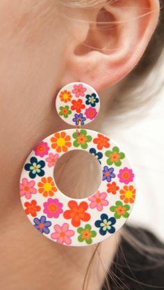 Embrace the vibrant spirit of the 1960s with these 60s Chunky Flower Hoop Earrings. Inspired by the bold and colorful fashion of the era, these earrings feature chunky flower-filled hoops that exude a retro charm. Crafted from lightweight acrylic, these earrings offer comfort without compromising on style. The posts are made of stainless steel, coated in 18k gold for an added touch of elegance, and are nickel-free to ensure a comfortable wearing experience. Product Details: Design: The 60s Chunk Vintage Summer Hoop Earrings, Retro Multicolor Flower Jewelry, Multicolor Retro Jewelry For Spring, Retro Flower-shaped Jewelry For Summer, Fun Multicolor Flower Earrings, Vintage Multicolor Earrings For Spring, Multicolor Vintage Earrings For Spring, Retro Flower Earrings For Spring, Retro Spring Flower Earrings