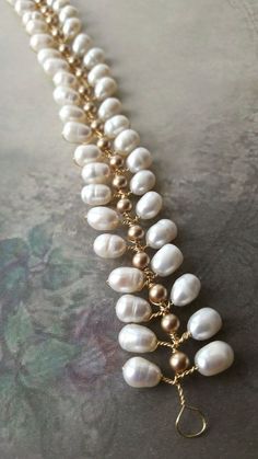 a long necklace with pearls and gold chains