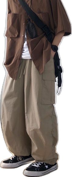 Baggy Tapered Leg Bottoms With Cargo Pockets, Oversized Parachute Pants With Pockets For Spring, Oversized Khaki Casual Pants, Baggy Wide Leg Khaki Bottoms, Oversized Utility Bottoms For Spring, Beige Bottoms With Side Pockets For Streetwear, Urban Style Khaki Pants For Summer, Khaki Oversized Pants With Pockets, Oversized Khaki Pants With Pockets