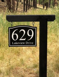 a black and white sign that reads 529 lakeview drive in front of some trees