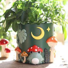 a potted plant sitting on top of a wooden table next to mushrooms and plants