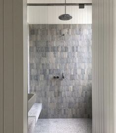 a walk in shower sitting inside of a bathroom