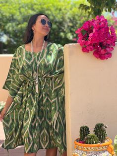 Introducing the Gallipoli Green Ikat midi kaftan dress, a captivating blend of Italian flair and exotic allure. With its lush green ikat print inspired by the landscapes of Gallipoli, this dress exudes effortless elegance and timeless charm. Slip into this breezy silhouette and let it transport you to sun-drenched shores and endless summer days, embodying the essence of Italian sophistication with a global twist. This Gallipoli Green silk is exclusively printed for Pax Philomena in Como, Italy a Summer Ikat Print Maxi Kaftan, Green Ikat Print Summer Dress, Bohemian Silk Dress With Ikat Print, Green Printed Kaftan With Kimono Sleeves, Bohemian Green Midi Dress For Beach, Bohemian Green Midi Dress For Beach Cover-up, Green Bohemian Tunic Midi Dress, Green Maxi Dress With Kimono Sleeves For Vacation, Green Printed Beachwear Dress