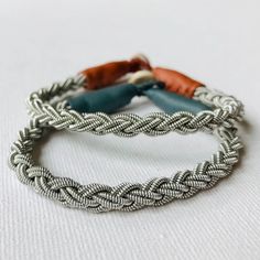 This is a round braided model is braided with a coarse, high quality pewter/silver thread and is finished off with reindeer leather in colour of your choice. Sleek and stylish and easy to wear. It is ice to wear in combination with other of my traditional Sami bracelets. For same model but with less coarse thread: https://www.etsy.com/se-en/listing/1745269085/sami-handmade-traditional-bracelet-in?ref=listings_manager_grid PLEASE  NOTE:! I offer free standard shipping. If you would like traceable Nickel-free Silver Braided Bracelet For Friendship, Bohemian Silver Bracelet With Waxed Cord, Nickel-free Silver Braided Bracelets, Silver Braided Friendship Bracelet, Artisan Braided Bracelet Gift, Silver Bracelet With Sliding Knot And Waxed Cord, Silver Bracelet With Sliding Knot In Waxed Cord, Silver Braided Bohemian Bracelets, Silver Adjustable Bohemian Braided Bracelet